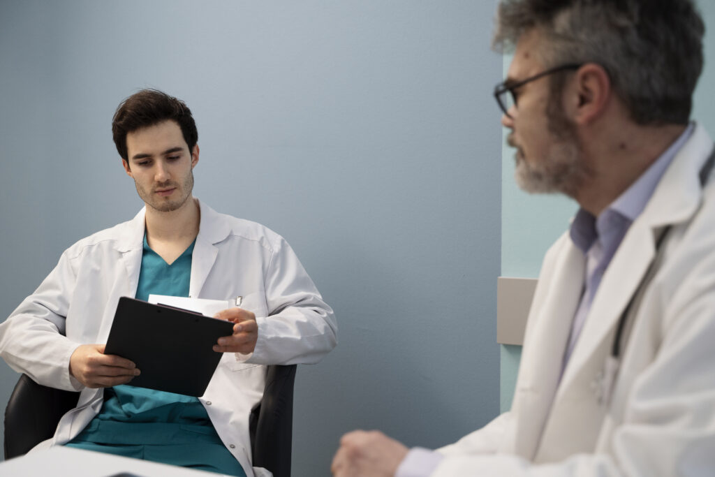The current image has no alternative text. The file name is: medium-shot-doctors-chatting-work-scaled.jpg